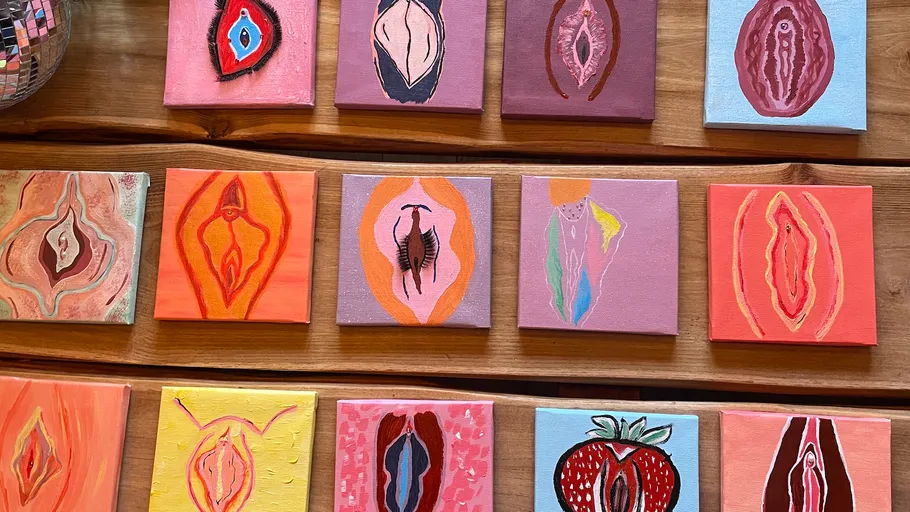 Colorful abstract artworks on wooden table.