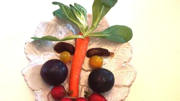 Vegetables and fruits arranged as a face.