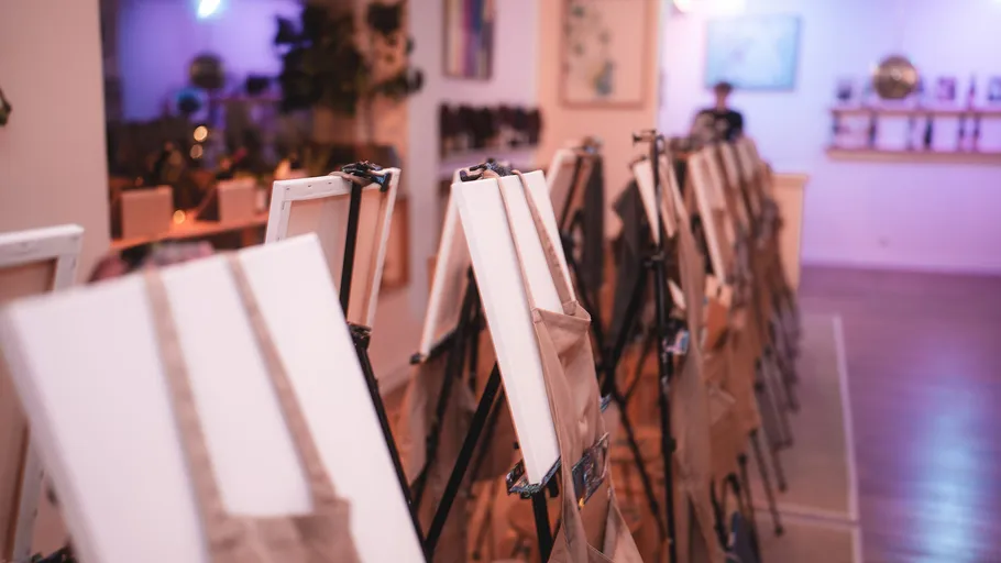 Empty canvases on easels in art studio.