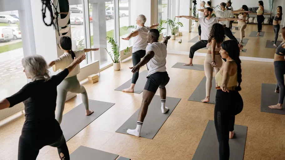 People practicing yoga in a studio.