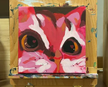 Buntes Katzenbild auf Holzstaffelei.