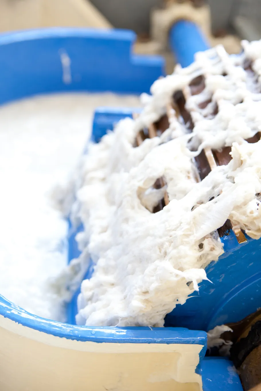 Industrial pulp machine processing white pulp.