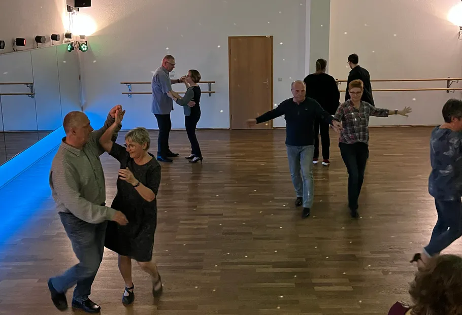Couples dancing in a mirrored studio.