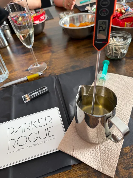 Thermometer in metal jug on a table.
