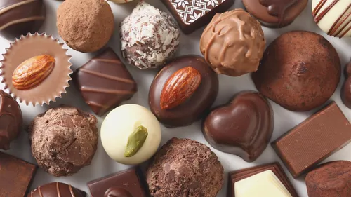 Verschiedene Pralinen auf flacher Oberfläche angeordnet.