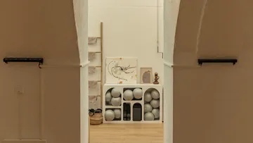 Yoga studio storage with balls and art.