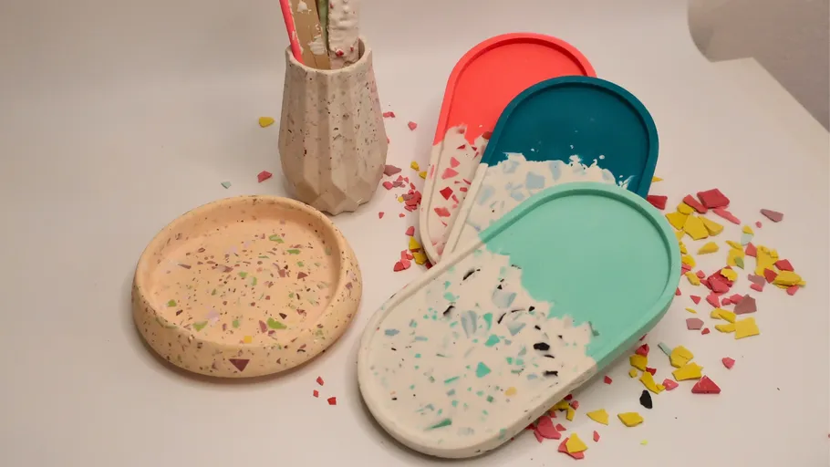 Colorful terrazzo trays on white surface.