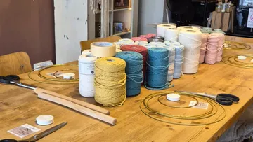 Yarn spools on table in craft room.