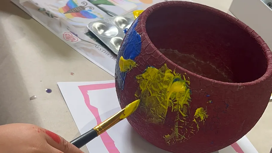 Hand painting pot with bright colors.