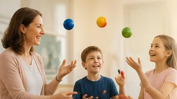 Three people juggling balls indoors.