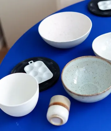 Dishes and a cup on a blue table.