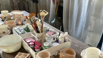 Art supplies on a wooden table.