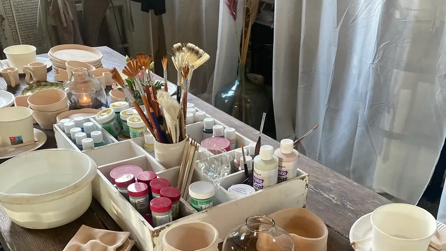 Art supplies on a wooden table.