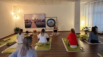 People meditating in a dimly lit room.