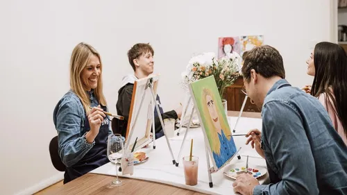 People painting in a group art class.