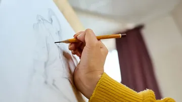 Hand sketches on paper indoors.