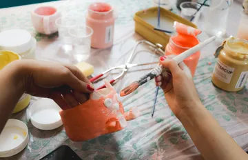 Hand painting ceramic model on table.