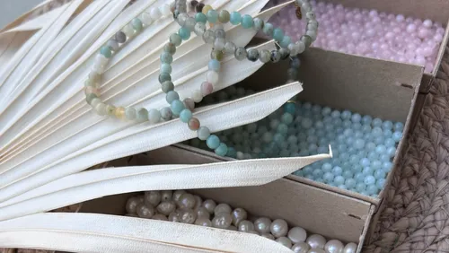 Beaded bracelets on dried palm leaves.