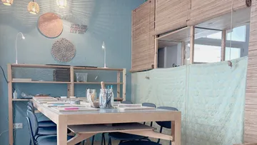 Table with crafting materials, cozy room.