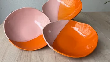 Three ceramic bowls, pink and orange colors.