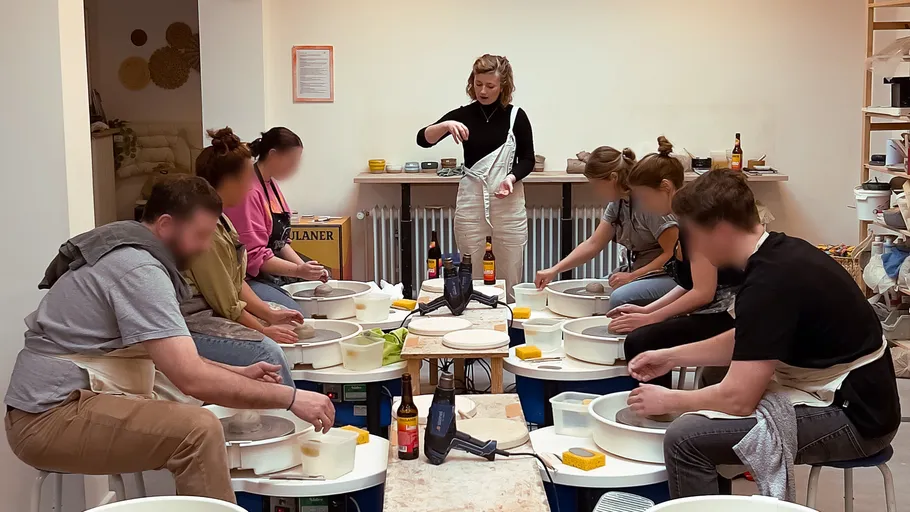 People making pottery in a studio.