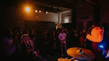 Musician performs in a dimly-lit room.