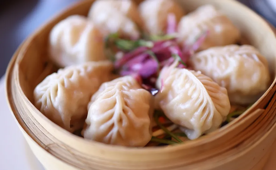 Dumplings served in a bamboo steamer.