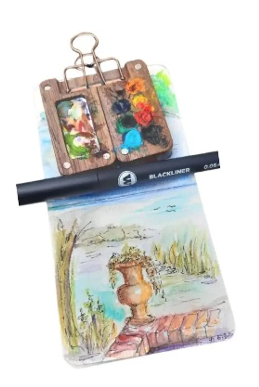 Paint palette and pen on watercolor sketch.