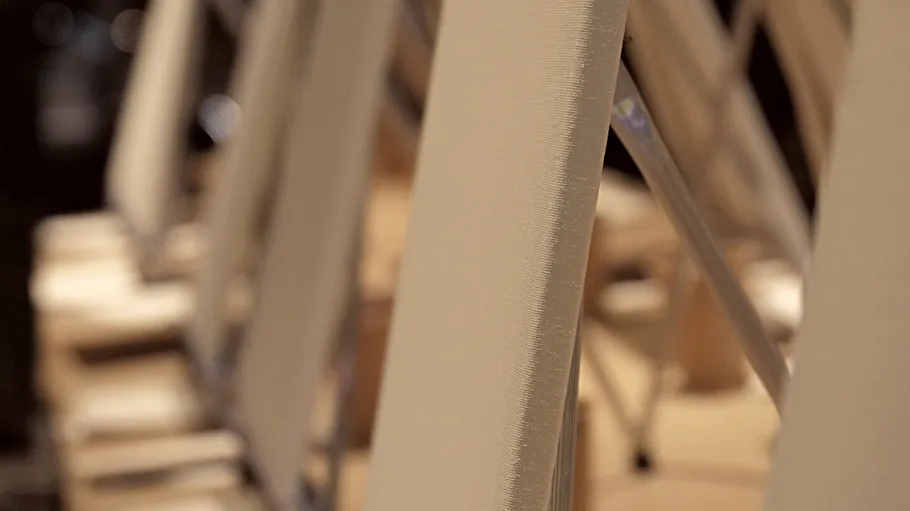 Chairs stacked in a row indoors.