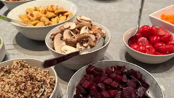Assorted bowls of fresh vegetables on table.