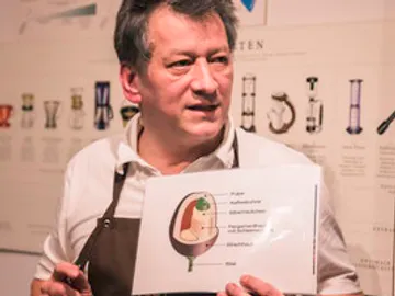 Man presents a diagram of the structure of an object.