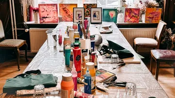 Art supplies arranged on a table in studio.