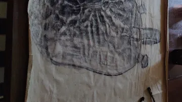 Charcoal drawing on paper in dim lighting.