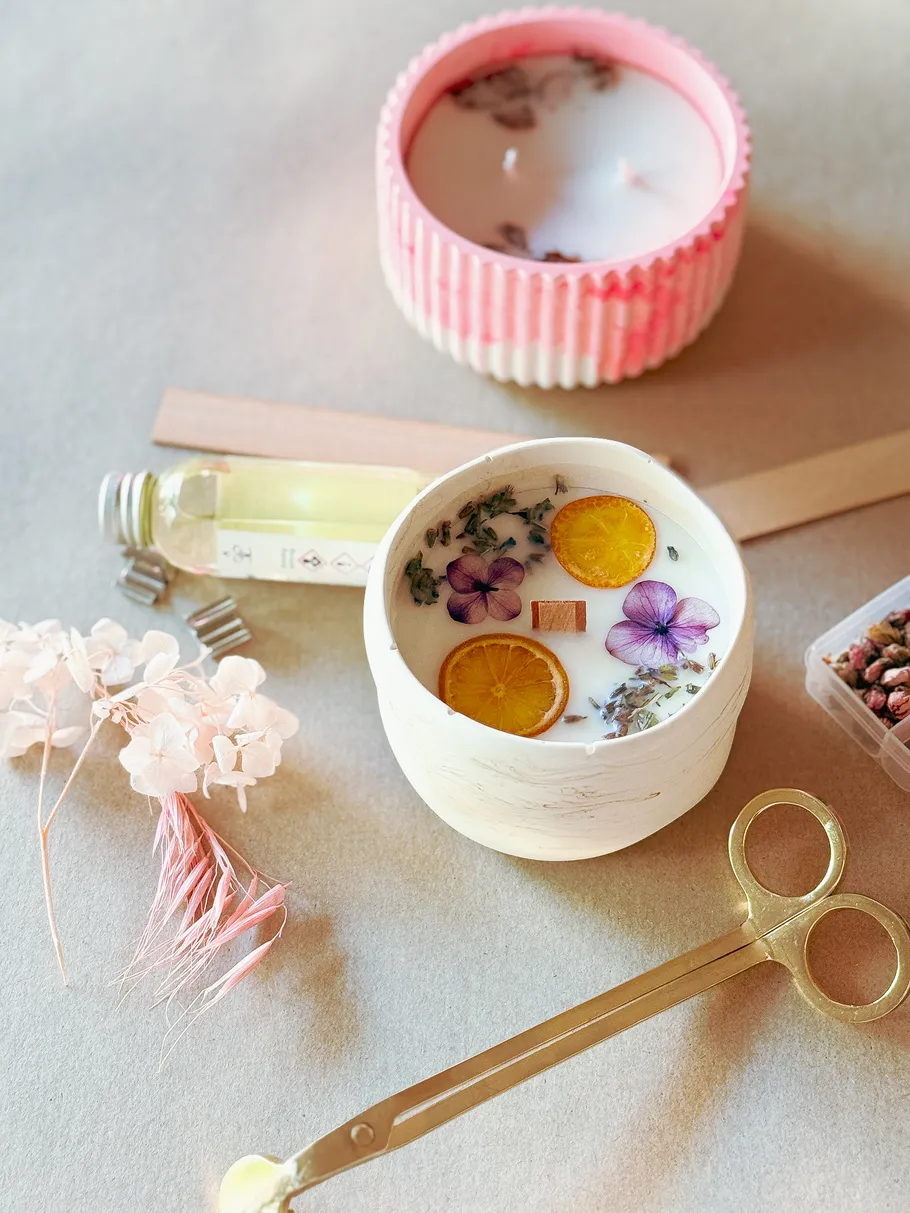 Decorative candles with flowers on a table.