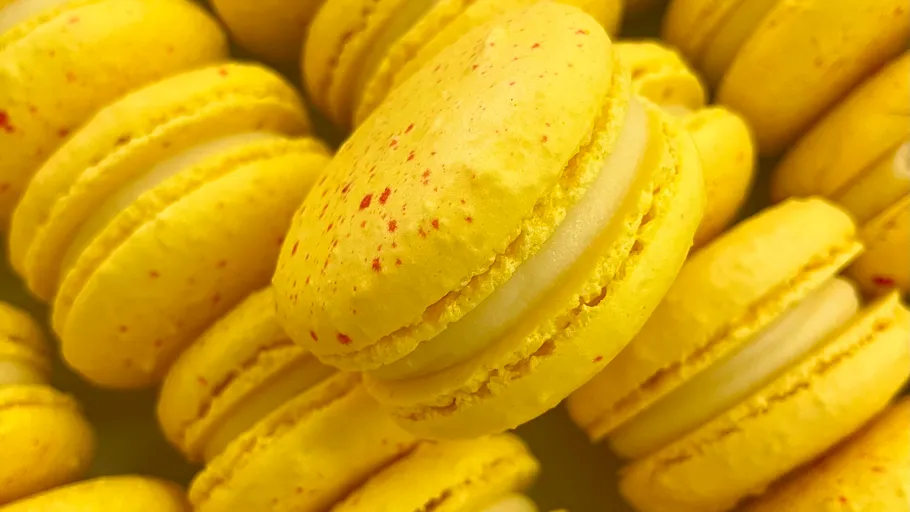 Yellow macarons stacked close together.