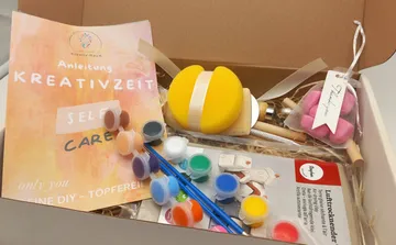 DIY kit with paints and tools in box.