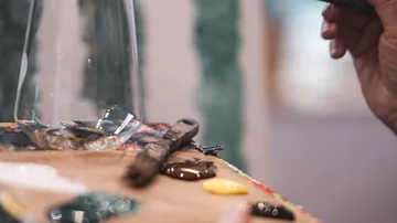 Palette with paint and brushes in studio.