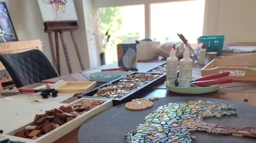 Mosaic tree artwork on wooden table.