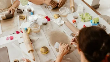 People crafting with clay at a table.