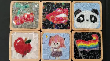 Mosaic coasters with various colorful designs.