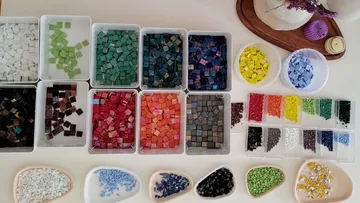 Colorful mosaic tiles arranged on a table.