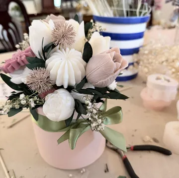 Soap flowers arranged in a pink box.