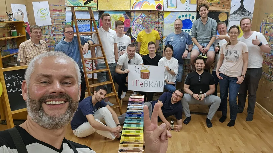 Group of people posing in art studio.