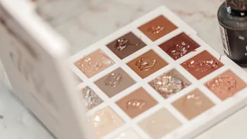 Eyeshadow palette with neutral colors displayed.