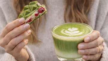 Matcha latte and chocolate in hands