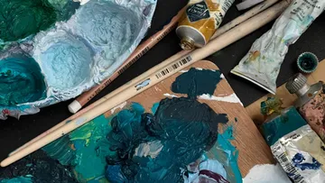 Paint tubes and palette with brushes.
