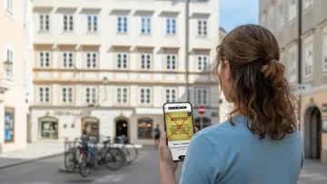 Person using tablet in a city square.