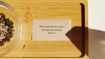 Wooden tray with quote and seeds.