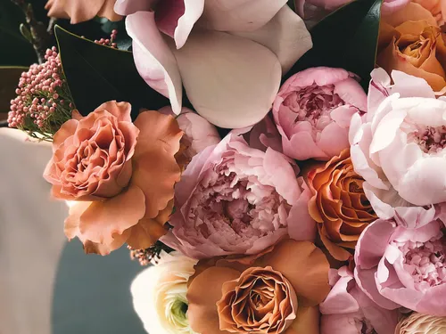 Different colored flowers are lush in an arrangement.