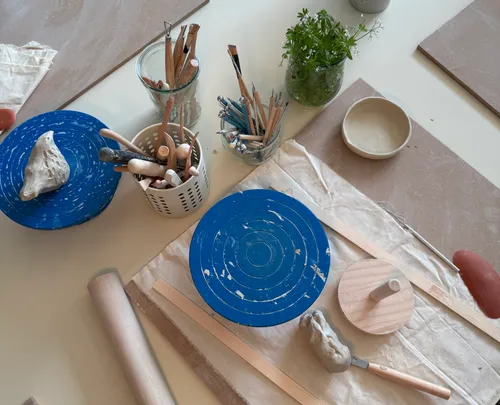 Pottery tools arranged on a workshop table.